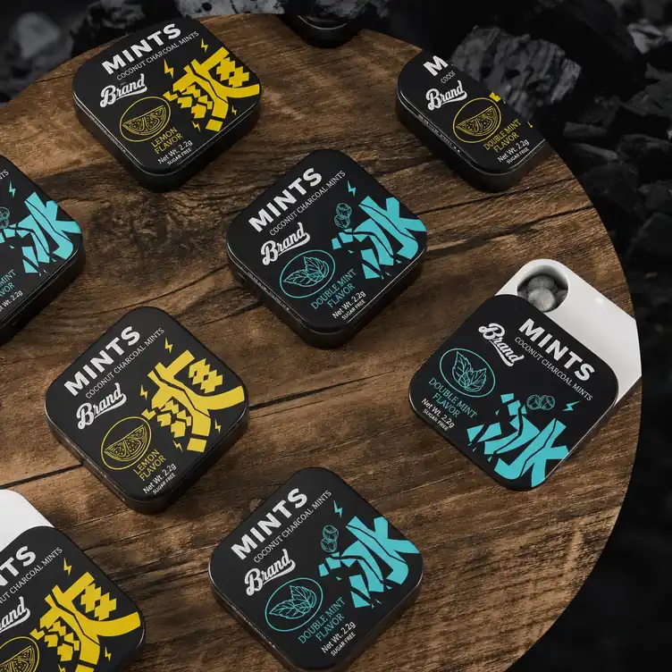 Coconut charcoal mint candy tins on wood