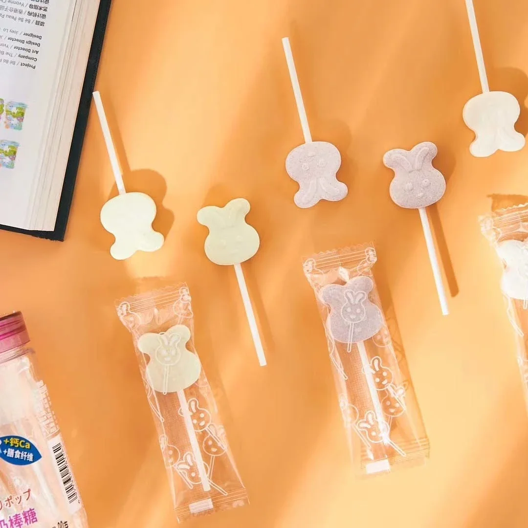 Milk lollipops bear shapes orange background